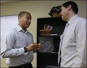 Alex Catchings, board member of the Alzheimer's Association of Northwest Ohio, left, speaking with Nick Vargas, development and communications coordinator of the organization. 