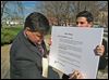  Joe McNamara, left, with campaign aide Andrew Grun-wald, signs an ethics pledge that calls on officials who supervise employees to ban them from campaigning for their bosses during normal business hours.