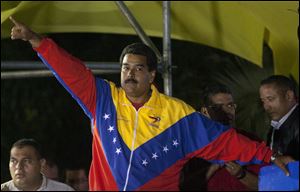 Venezuela's newly elected President Nicolas Maduro celebrates his victory after the official results of the presidential elections were announced, at the Miraflores Palace in Caracas, Venezuela, late Sunday.