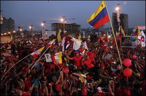 Nicolas Maduro, Hugo Chavez's hand-picked successor, greets supporters from the top of a vehicle as he arrives at Bolivar Avenue for his final campaign rally before Sunday's vote. Mr. Maduro won the election with 51 percent of the vote over his opponent Henrique Capriles.