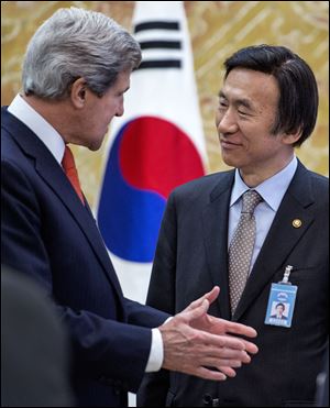 John Kerry and South Korea's Foreign Minister Yun Byung-se share a few words during the U.S. secretary of state's first-ever visit to Seoul.