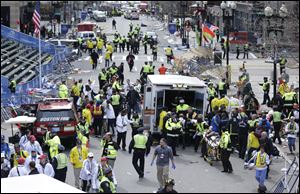 Medical workers aid injured people at the finish line of the 2013 Boston Marathon following an explosion in Boston, Monday afternoon.