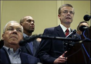 FBI Special Agent in Charge Richard DesLauriers, far right, speaks as Boston Mayor Thomas Menino, left, and Mass. Gov. Deval Patrick, center, listens during a news conference in Boston today.
