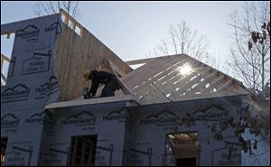 A worker helps frame a new home under construction in Matthews, N.C., in March.