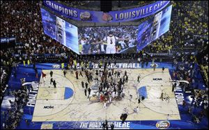 Louisville players celebrated after the April 8 NCAA basketball title game in which they beat the Michigan Wolverines.