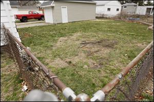 The backyard of Joan Rutherford, where a body was found by police. Her neighbor, Bryan Loyer, shot and killed a man who apparently was trying to break into his house at 4546 Douglas Ave. in Toledo.