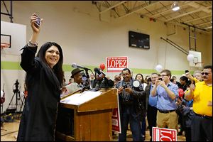Anita Lopez holds up a cell phone and urges supporters to text her campaign to get on her list for updates. She spoke at a rally at the Aurora Gonzalez Community Center, where she officially announced her run for mayor.