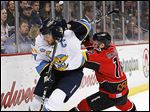  Toledo’s Kyle Rogers, left, battles for the puck with Cincinnati's David MacDonald. The Walleye made the playoffs for the first time since 2010 but lost in the first round again.