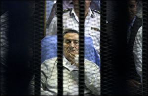 Egypt's deposed President Hosni Mubarak attends a hearing session in his retrial on appeal in Cairo, Egypt, Monday.