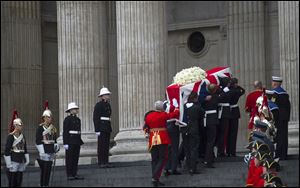 The Union flag draped coffin, holding the body of British former Prime Minister Margaret Thatcher, is carried up the stairs to St Paul's Cathedral. It is the second time in history the Queen will be attending the funeral of a prime minister, after Winston Churchill.