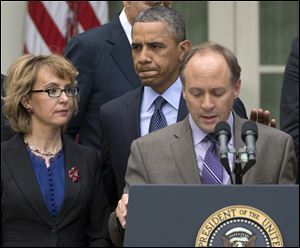 President Barack Obama arrives to participate in a news conference in the Rose Garden of the White House about measures to reduce gun violence. With him is former Rep. Gabby Giffords, left, and Mark Barden, the father of Newtown shooting victim Daniel.  