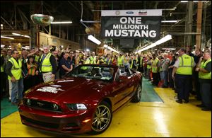 Ford's Flat Rock Assembly Plant employees cheer Wednesday as the millionth Ford Mustang is driven off the assembly line in Flat Rock, Mich. A million Mustangs have rolled off the Flat Rock assembly since production moved there in 2004. The car was built at Ford's Rouge factory for four decades before moving to Flat Rock in 2004.