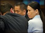  Catherine Kieu sits next to her attorney, deputy public defender, Frank Bittar, before opening statements Wednesday, April 17, 2013 in Santa Ana, Calif. 