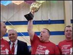 Shawn Zaborski hoists the trophy as winner of the 2013 Polish-American Community of Toledo’s Kielbasa Cook-off, making his team, Polish Village Kielbasa, the 'Kielbasa King' for the year. Celebrating with him are, from left, Ladden Vernon; Stan Machosky, president of the PACT board of directors, and Eric Smigelski. 