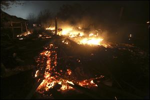 The remains of a home burn early Thursday morning after a fertilizer plant exploded Wednesday night in West, Texas. 