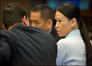 Catherine Kieu sits next to her attorney, deputy public defender, Frank Bittar, before opening statements Wednesday, April 17, 2013 in Santa Ana, Calif. 