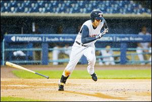 The Mud Hens' Quintin Berry bunts safely to first to advance teammate Bryan Holaday against the Columbus Clippers during the fourth inning at Fifth Third Field on Thursday.