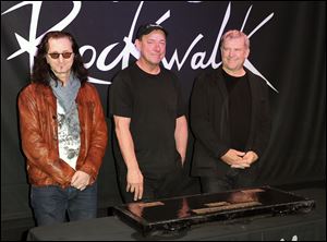 Members of the band Rush are, from left, Geddy Lee, Neil Peart, and Alex Lifeson. They are among the 2013 group of Rock and Roll Hall of Fame inductees.