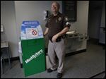  Sylvania Township Police Sgt. Clarence Whalen shows the green medical waste return box at the township police station. 