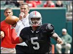  Braxton Miller passes during Ohio State's spring game under the watch of coach Urban Meyer. Miller, who will be a junior, is expected to be a Heisman Trophy favorite next season.