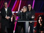  Alex Lifeson, center, Neil Peart, left, and Geddy Lee, right, of Rush accept their band's induction into the Rock and Roll Hall of Fame.