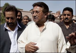 In this Monday, April 15, 2013 photo, Pakistan's former President and military ruler Pervez Musharraf arrives under tight security to address his party supporters at his house in Islamabad, Pakistan. Musharraf and his security team pushed past policemen and sped away from a court in the country’s capital on Thursday after his bail was revoked in a case in which he is accused of treason. (AP Photo/B.K. Bangash)