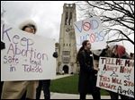  University of Toledo graduate student Candice Brothers, City Council Green Party candidate Sean Nestor, and Taylor Scribner of Bowling Green protested Friday the decision of UTMC President Dr. Lloyd Jacobs to cancel a transfer agreement with a local abortion clinic.