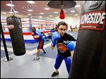  Four-time national Police Athletic League winner Monica Van Pelt, 17, works out at a punching bag during at the league’s temporary facility at the former Riverside Hospital in North Toledo.