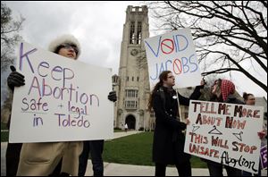 University of Toledo graduate student Candice Brothers, City Council Green Party candidate Sean Nestor, and Taylor Scribner of Bowling Green protested Friday the decision of UTMC President Dr. Lloyd Jacobs to cancel a transfer agreement with a local abortion clinic.