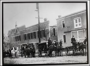 A copy of a photo of a funeral procession at the original Coyle Funeral Home on Broadway at Logan Street, taken in 1905. Copy made on April 16, 2013.