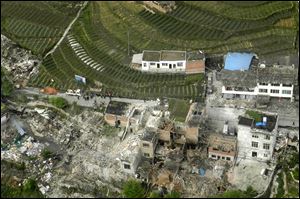 This aerial photo released by China's Xinhua news agency shows destroyed houses after a powerful earthquake hit Taiping town of Lushan County in Ya'an City, southwest China's Sichuan Province.