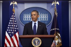 President Barack Obama gets ready to speak in the Brady Press Briefing at the White House in Washington, Friday, April 19, 2013, regarding the Boston Marathon bombing.