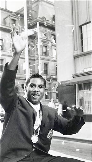 Wilbert ‘Skeeter’ McClure, who boxed in the Toledo PAL, waves as he rides in a parade through downtown Toledo in September, 1960, after winning a gold medal in the 1960 Rome Olympics.