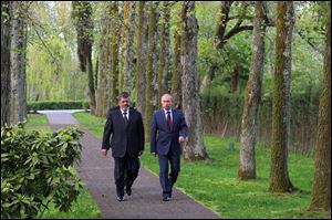 Russian President Vladimir Putin, right, and Egyptian President Mohammed Morsi walk together Friday after talks in the Black Sea resort of Sochi, Russia.