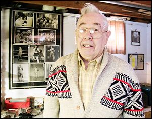 Ramon ‘Buddy’ Carr, above, the former trainer-coach and brains behind Toledo’s Police Athletic League program, is still spry at 87 — but he greets visitors by admitting he’s no longer 'at his fightin’ weight.'  At right, a much younger Mr. Carr works with Archie Moore, who became the world light heavyweight champion in 1952. 