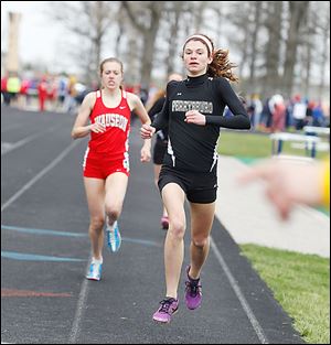 Perrysburg’s Courtney Clody leads Wauseon's Taylor Vernot in the 1,600-meter run. Clody won the event.