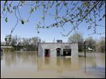  Bob Bailey tinkers with a pump as he tries to keep floodwater from the Mississippi River out of one of his rental properties. The town’s makeshift levee appeared to be holding Sunday. The river was expected to crest today.