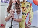  Bedford High student Megan McCormick with two of her favorite things: a microphone and a cardboard image of NASCAR racer Joey Logano, whom she met when she performed at a Virginia race.
