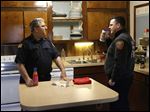  Firefighters Mike Street, left, and Brian Lisowski chat in the temporary Fire Station No. 1 on Brint and McCord roads in Sylvania. The department is using the three-bedroom home, owned by Lourdes University, until construction of the new station in downtown Sylvania is complete. 