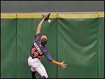  The Astros' Justin Maxwell cannot make the catch, giving the Indians' Yan Gomes a triple.