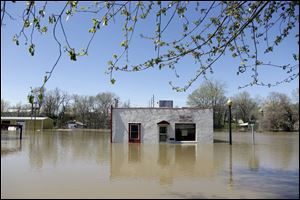 A restaurant sits surrounded by floodwater Saturday, April 20, 2013, in Louisiana, Mo. 
