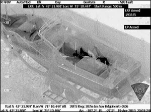 This image made available by the Massachusetts State Police shows 19-year-old Boston Marathon bombing suspect, Dzhokhar Tsarnaev, hiding inside a boat during a search for him in Watertown, Mass., Friday. He was pulled, wounded and bloody, from the boat parked in the backyard of a home in the Greater Boston area. 