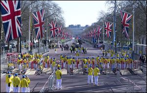 Volunteers in bright yellow get ready prior to the London Marathon in the Mall in London, today. Security has been stepped up in London following the recent bombs at the Boston Marathon.