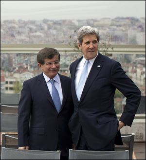 Turkish Foreign Minister Ahmet Davutoglu, left, shows U.S. Secretary of State John Kerry, the skyline of Istanbul before the start of a meeting on Sunday, April 21, 2013, in Istanbul, Turkey. Kerry is wrapping up a 24-hour visit to Istanbul with talks aimed at improving ties between Turkey and Israel and pushing ahead with Mideast peace efforts. (AP Photo/Evan Vucci, Pool) 