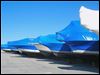  Shrink-wrapped boats sit in storage. The wrap would previously sit in landfills. Now, it is recycled into a material used in guardrails.