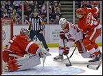  Red Wings goaltender Jimmy Howard stops a shot by Phoenix center Lauri Korpikoski as defenseman Jonathan Ericsson moves in.