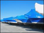  Shrink-wrapped boats sit in storage. The wrap would previously sit in landfills. Now, it is recycled into a material used in guardrails.