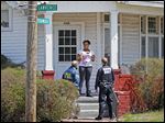  Angela Self talks to Dave Dustin, an FBI special agent, and Officer Melvin Haney of the Toledo Police Gang Unit at her home on Fernwood Avenue during their canvassing of the neighborhood.