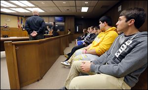 Anthony Wayne seniors Anthony Ulman, right, and Chris Wolfe, second from right, listen with other students from Pat Phillips’ business law class as they visit Judge Michael Goulding’s courtroom.