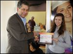  Ed Sitter, executive director of Greater Toledo Right to Life and Foundation for Life, presents Meghan Oberle with a certificate for her winning video for pro-life.
